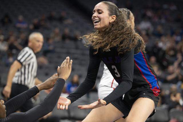 Christian Brothers’ Olivia Novi helps a teammate up during the CIF Sac-Joaquin Section Division II girls basketball championship at Golden 1 Center in Sacramento on Friday, Feb. 27.